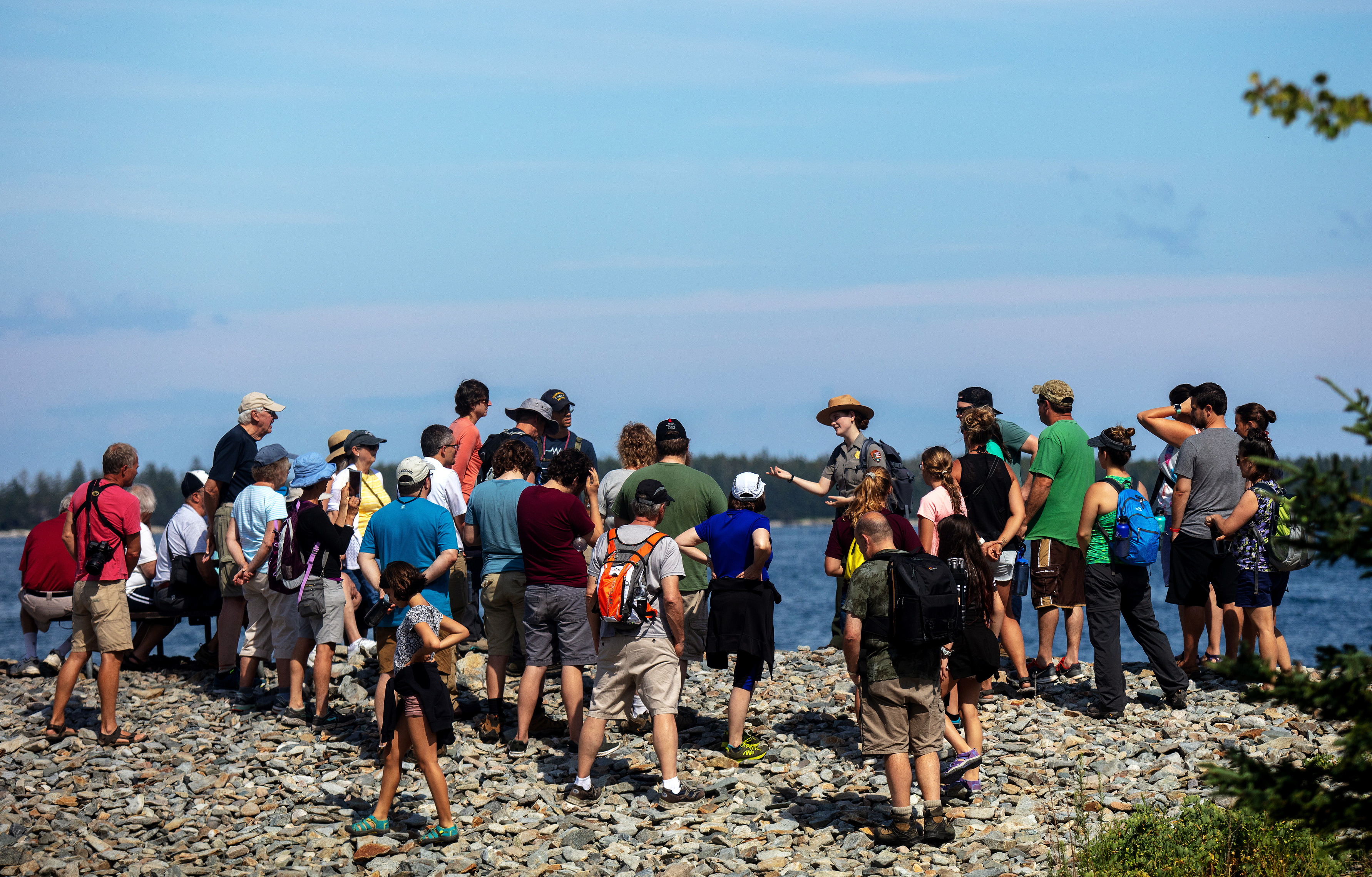 A park ranger speaks to about 35 people oputside