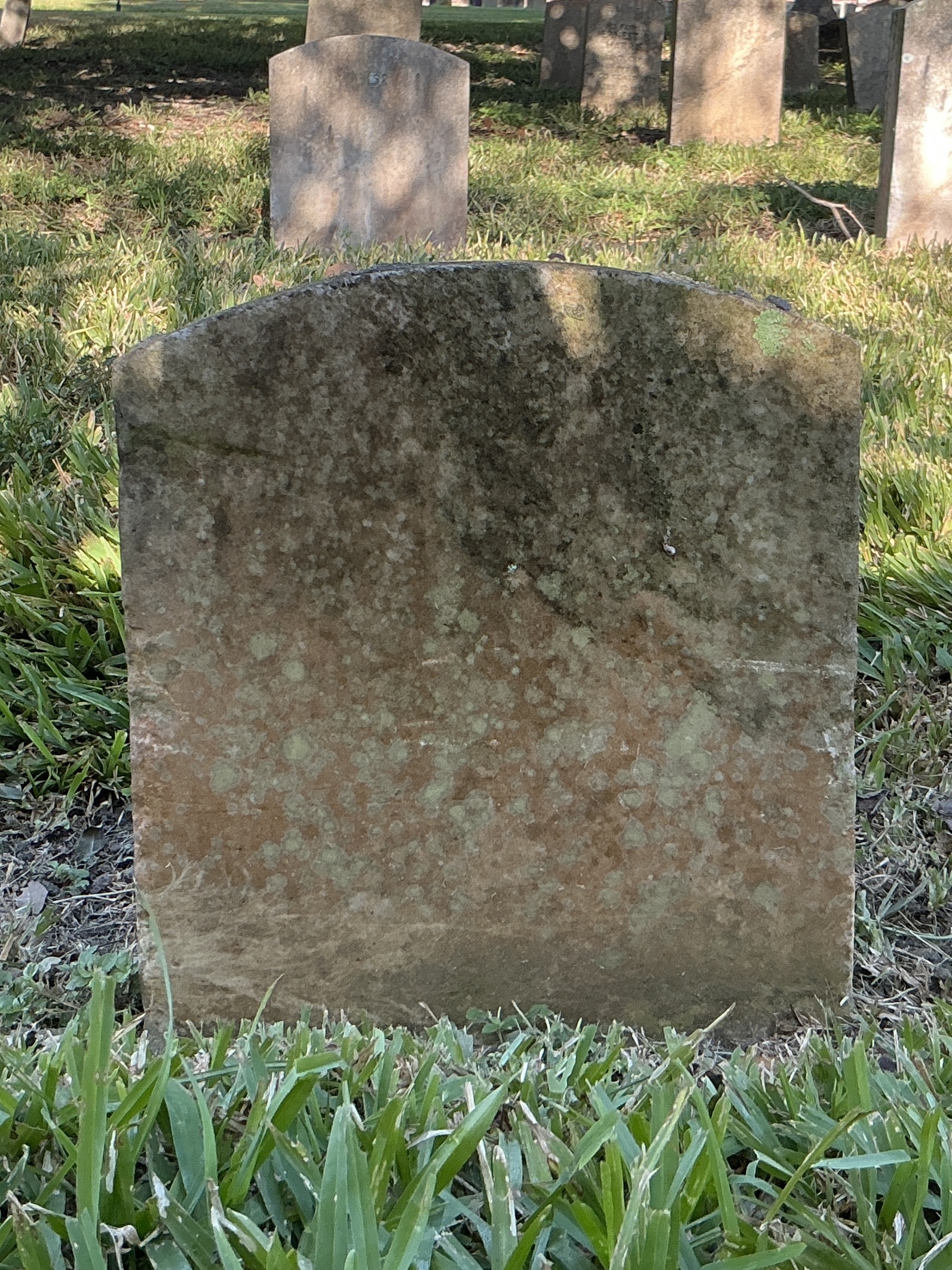 Back of upright marble headstone with flat face.