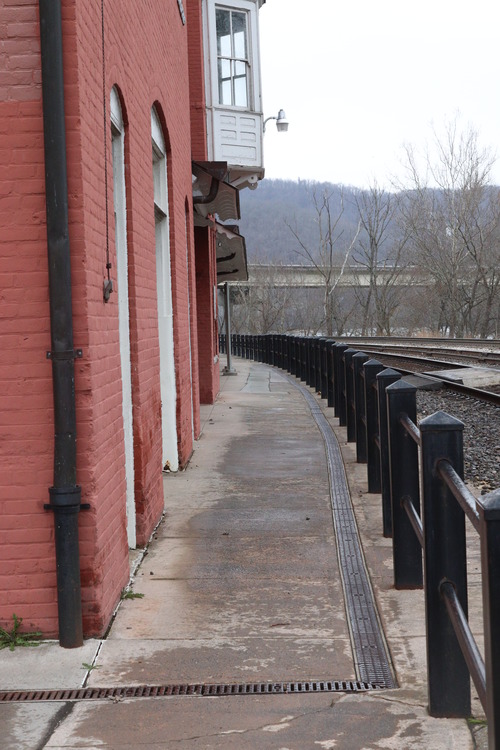 brick building along railroad tracks