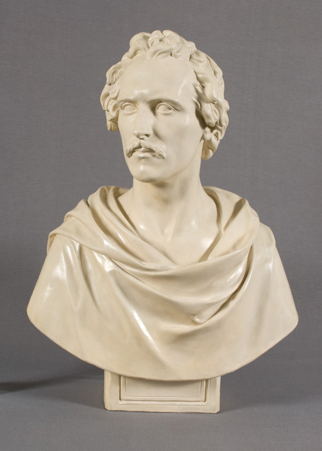 Off-white bust of man with short hair and mustache, wearing classical drapery around shoulders.