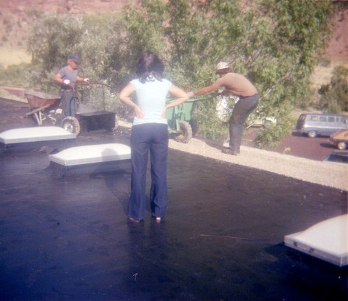 Workers operating roofing machine during the headquarters/visitor center roofing project.