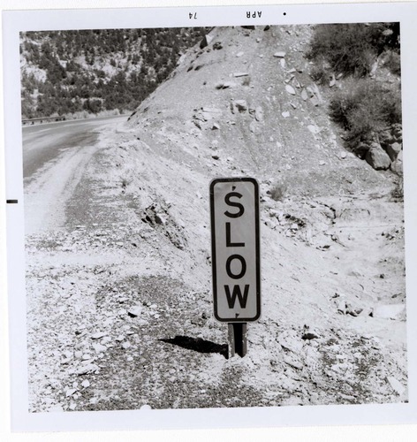 Road sign reading 'SLOW' in Kolob Canyon.
