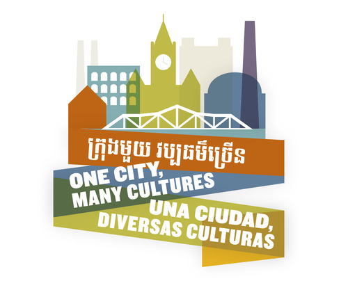 On a winding ribbon "One City, Many Cultures" is written in English, Spanish and Khmer. At the top of the logo a city skyline including a clocktower, smokestack, bridge and river sits.