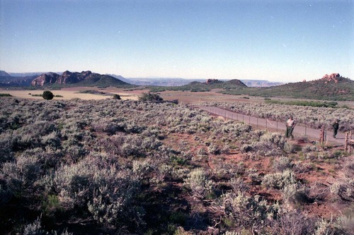 Color Photos of Cave Valley area. Men walking near fenceline.