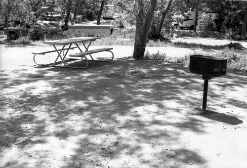 Empty campsite with picnic table and grill in South Campground.