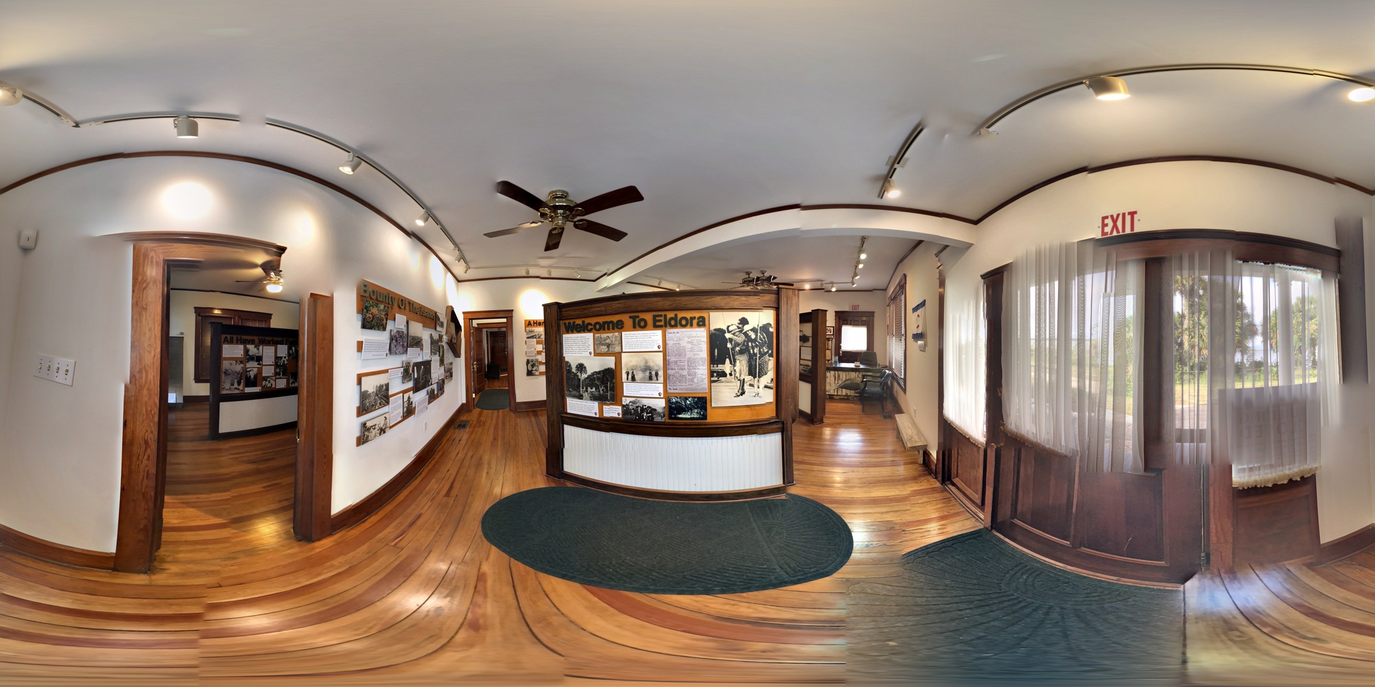 Wood floors, multiple photo displays, and white walls describes what is present. 