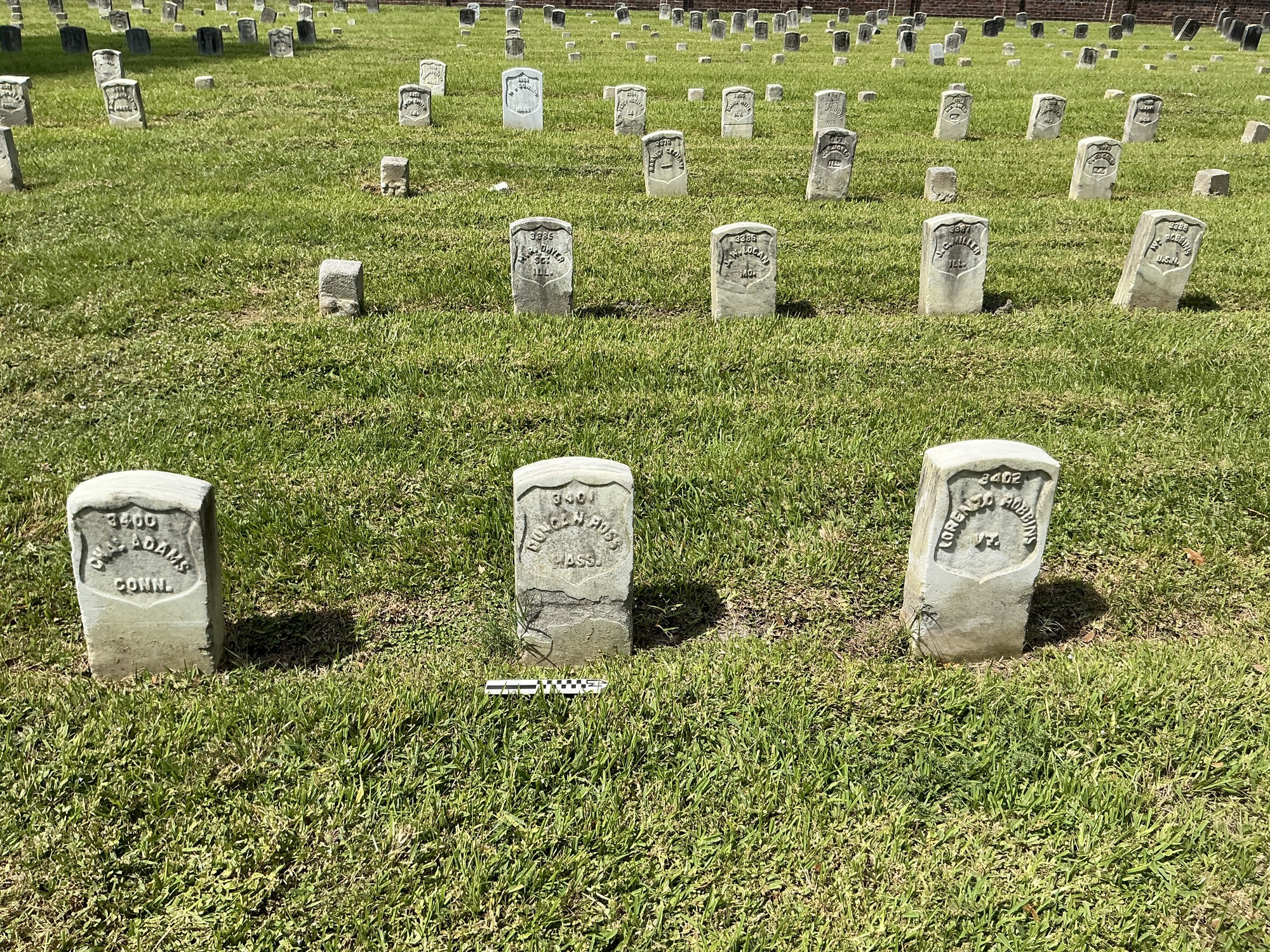 Extra image of historic upright marble headstone with recessed shield face.