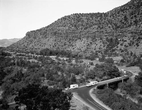 Oak Creek bridge and view of canyon- group of 75 motorhomes in caravan called the Fireballers, preparing to drive through tunnel.