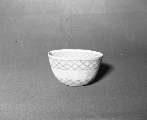 Mrs. Donald Segerstrom Collection. Object: Paiute hat. Dimensions: 5 1/4 x 8 1/2". Materials: split willow shoots, design in sunburned willow touched up with dye. Technology: three-strand twining start, three rows of plain twining over grouped warps, body of basket in diagonal twining. Photographed by Michael Dixon, January 1983. Catalogued by Craig Bates and Barbara Beroza. Yosemite Collections, National Park Service.