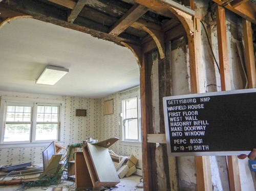 Reconstruction of a historic house has revealed the original masonry behind a doorway opening.