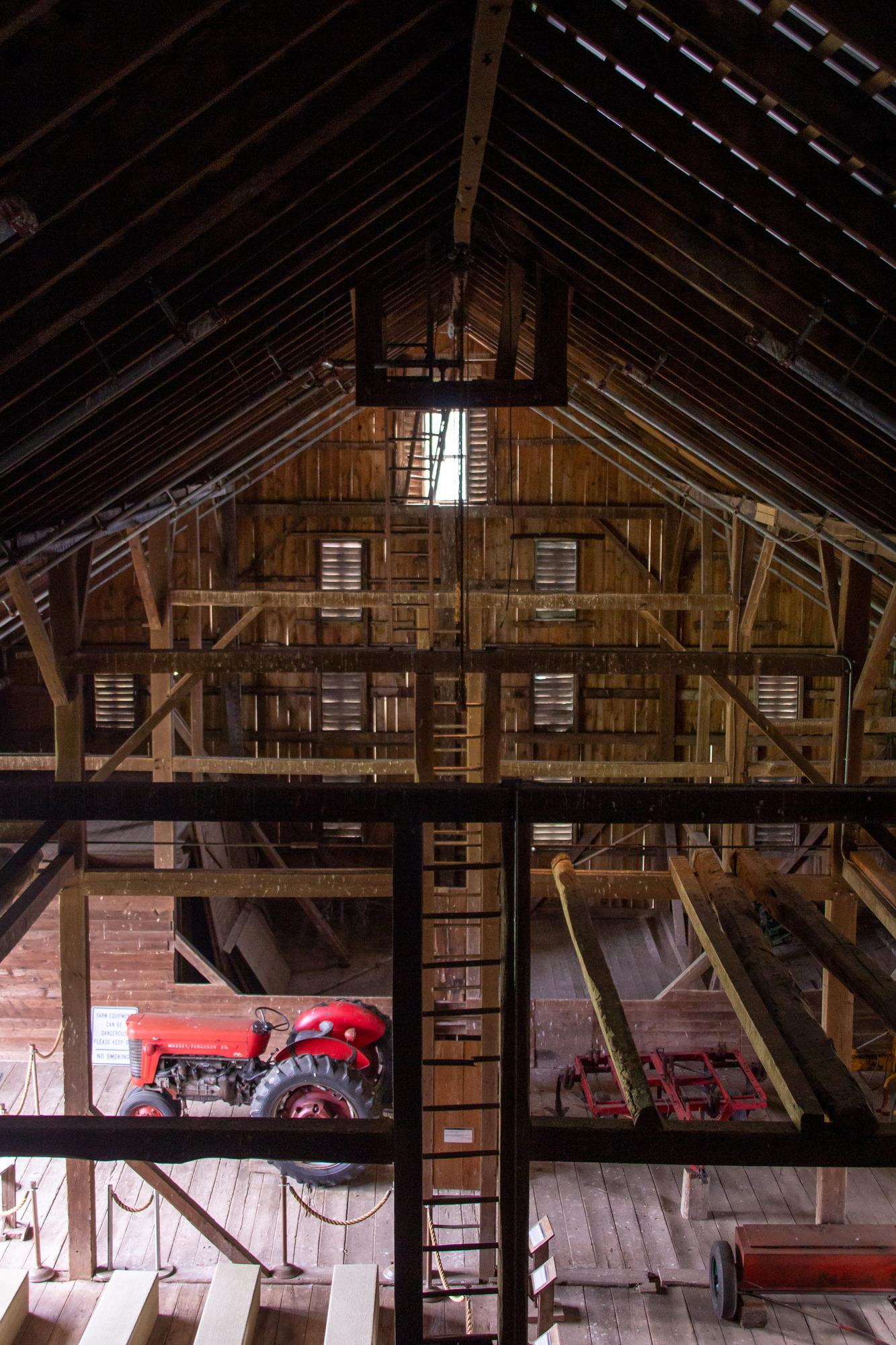 A birds eye view of a barn with farm equipment in it.