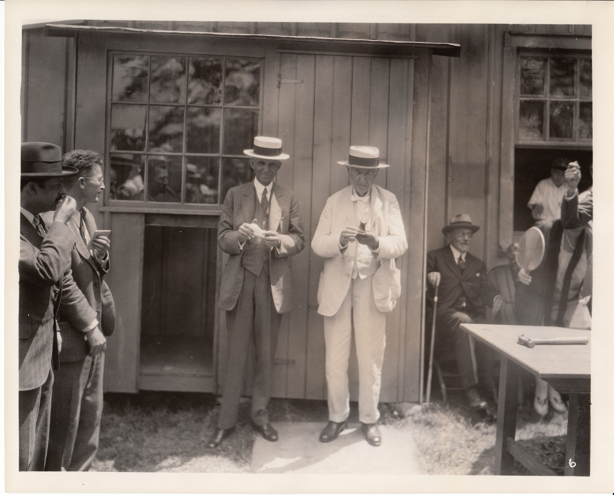Henry Ford and Thomas Edison holding incandescent lamps at presentation of Glass House.