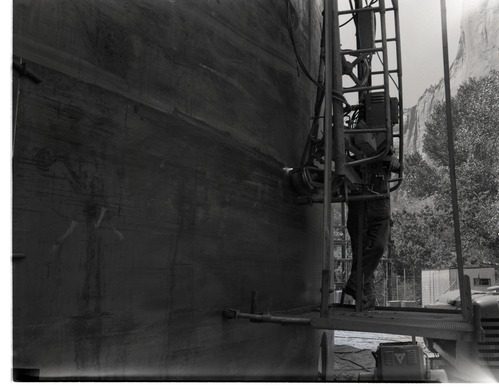 Construction of million gallon water tank at Birch Creek, with welding crews working on walls.