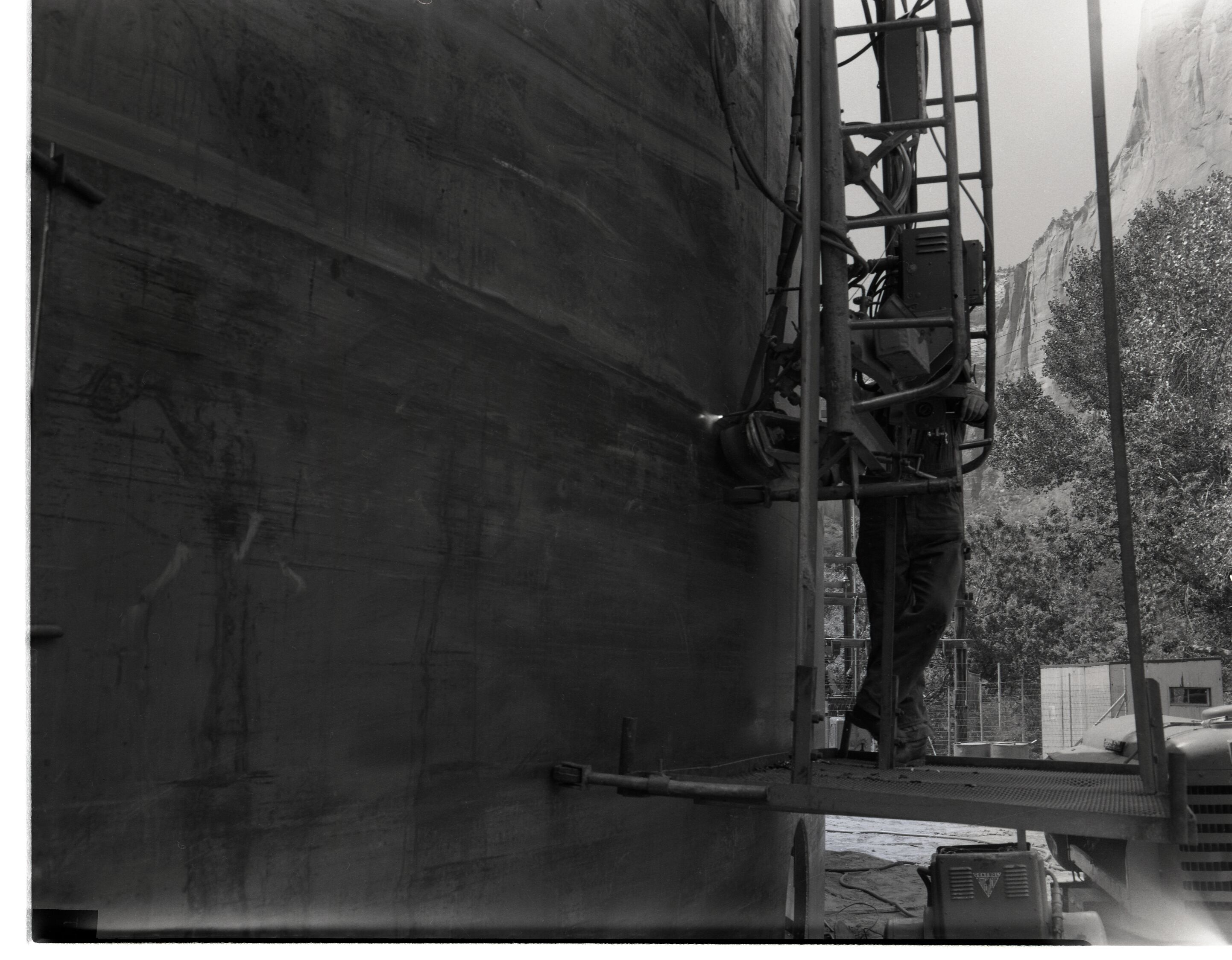 Construction of million gallon water tank at Birch Creek, with welding crews working on walls.
