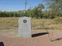 A monument is in the middle of a field.