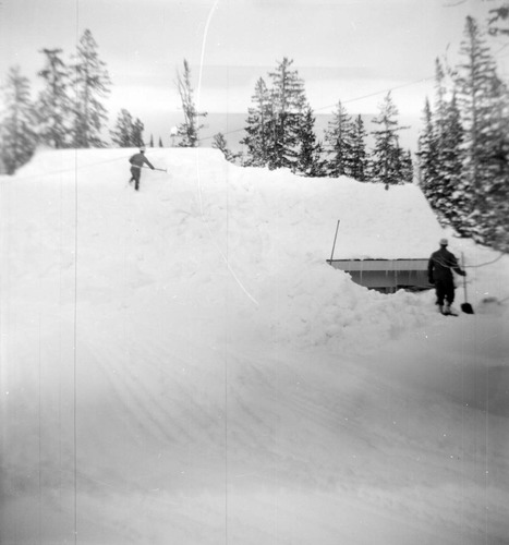 BW Photos showing rangers digging out the visitor center from snowdrift.