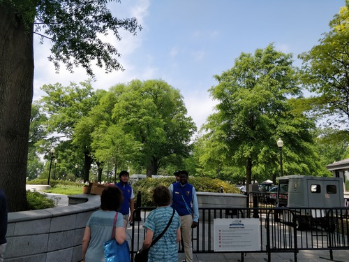 Entrance to park with bike rack and NPS volunteers greeting visitors.