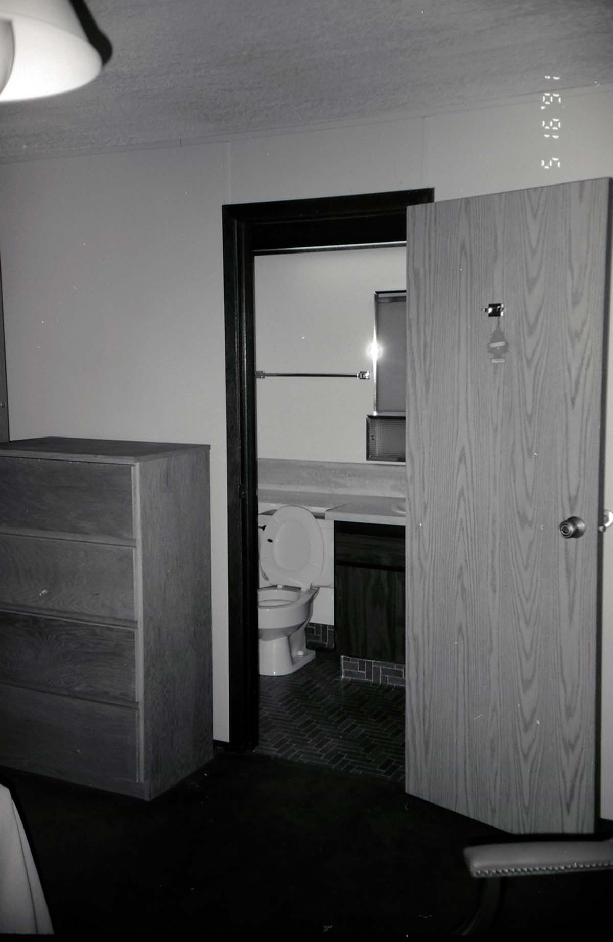 Bedroom and bathroom in barracks. [Image possibly for comparative housing study]