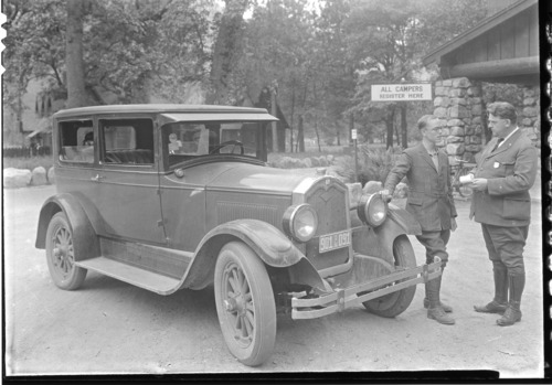 Ranger E. R. Reed questioning a visitor as to road conditions.