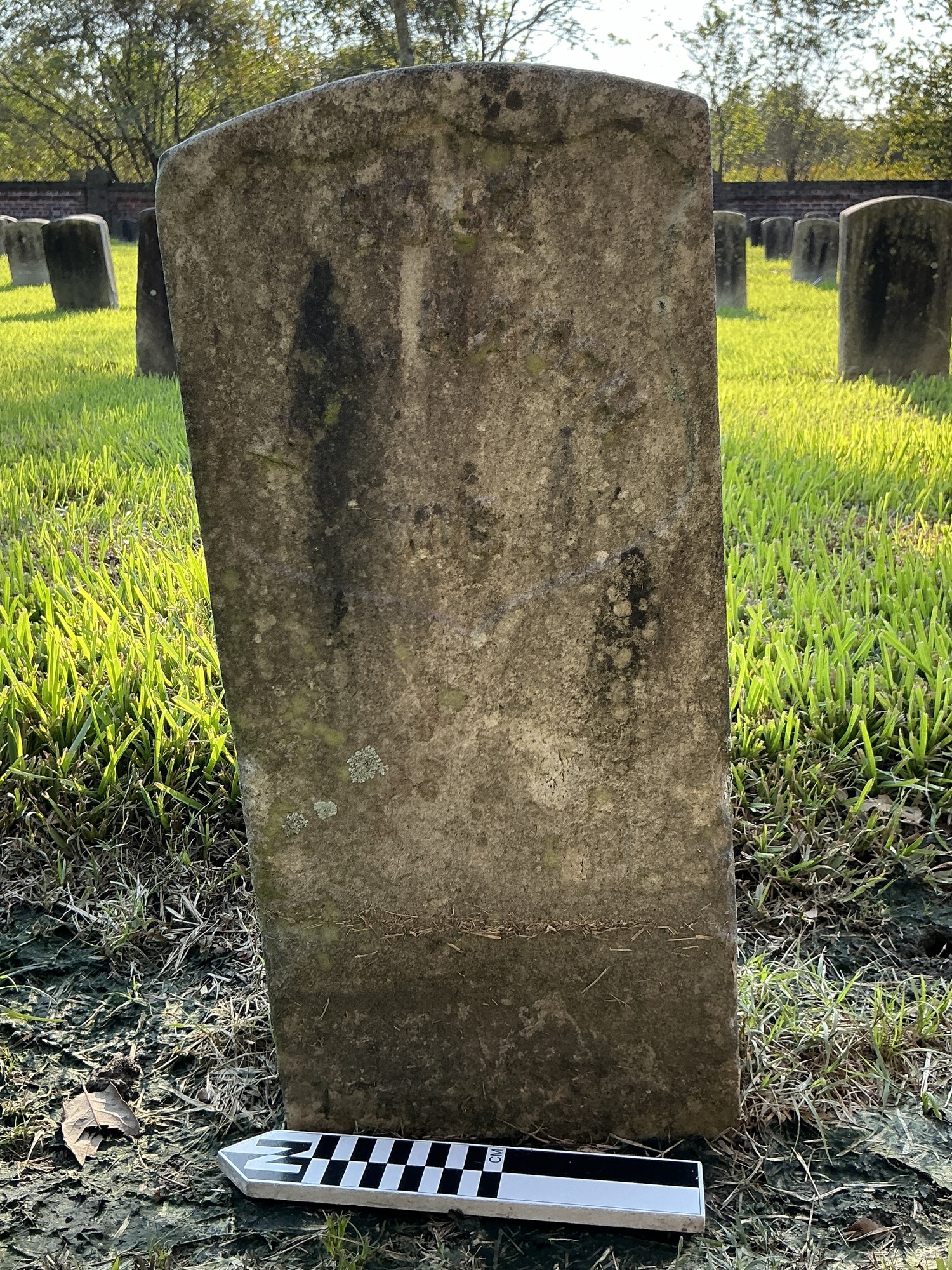 Extra image of historic upright marble headstone with recessed shield face.