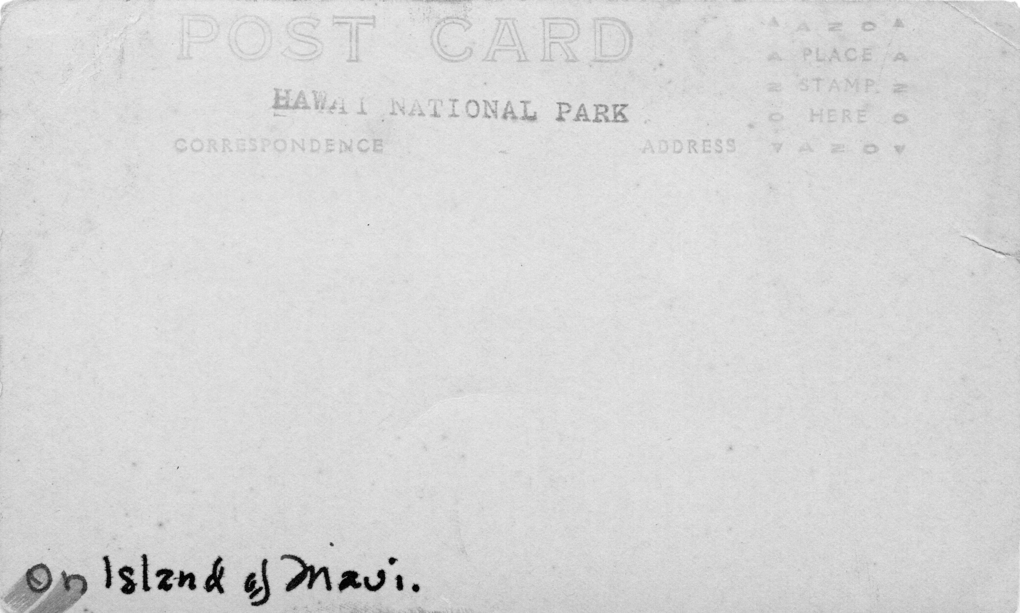 The backside of an image of eleven men, including Thomas Boles, on horseback. The words "Post Card" are centered at the top of the card. Below "Post Card" are two subtitles, "Correspondence" and "Address." In between "Post Card" and the subtitles, "Hawaii National Park" is stamped. On the top right corner there is a stamp box. The stamp box is outlined with "AZO" and triangles on each corner, with the instructions "Place stamp here" at the center.  Along the bottom left edge of the image, "On Island of Maui," is written in ink.