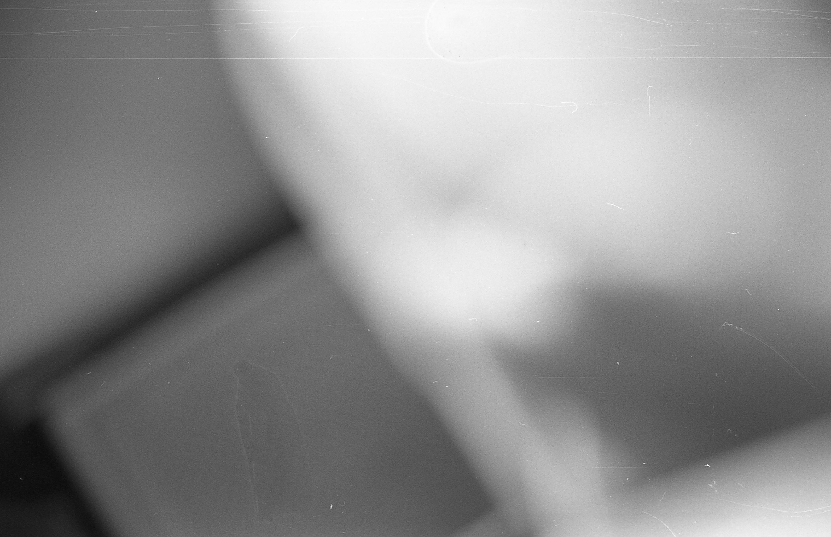 A black and white blurry image that was taken by accident. It is hard to see what is in the image.