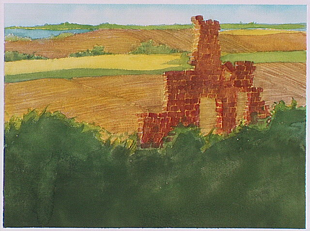 Ruins of a brick chimney in a plowed field.