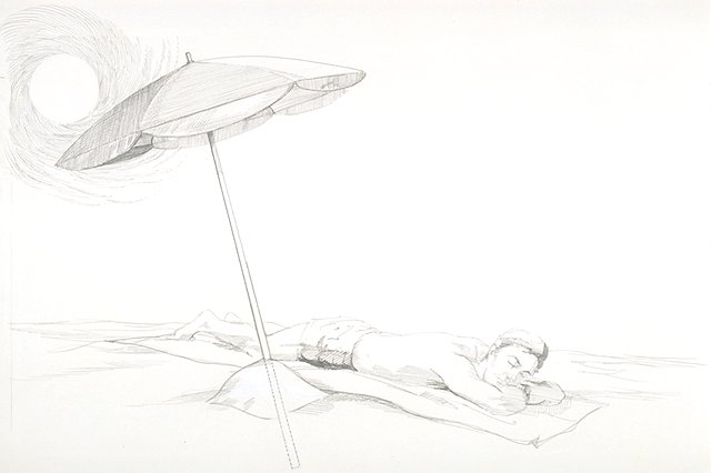 A sun bather lying on a towel lying under a properly installed beach umbrella.