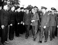 HPC-000661. CCC (Civilian Conservation Corps) Camp NP-14, Rock Creek Park, October 14, 1941. Front (left to right): J. J. McEntee, 2d Director, CCC; Edward, the Duke of Windsor;  and Lt. Hugo Ruggiero, Comanding Officer of CCC Camp NP-14, Rock Creek Park.