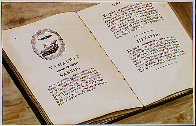 Book opened to pages from "Nez Perce Laws" printed by Henry Spalding on the mission press.