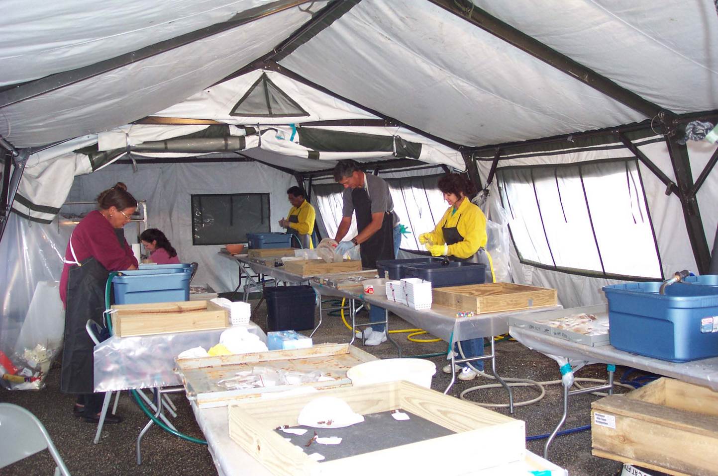 Archeological metals being rinsed in successive water baths to remove contaminants.