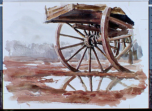 Wagon in muddy field.