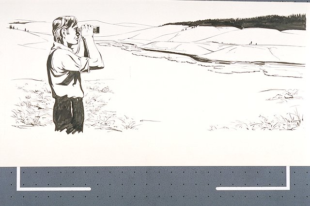 A man using a pair of binoculars to view Yellowstone National Park's wildlife and terrain in the distance.