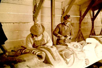 HPC-000492.jpg. CCC (Civilian Conservation Corps) era restoration of Totem Poles, Sitka (Alaska). Image dates to the 1930s but exact year unknown. Sitka National Historical Park.