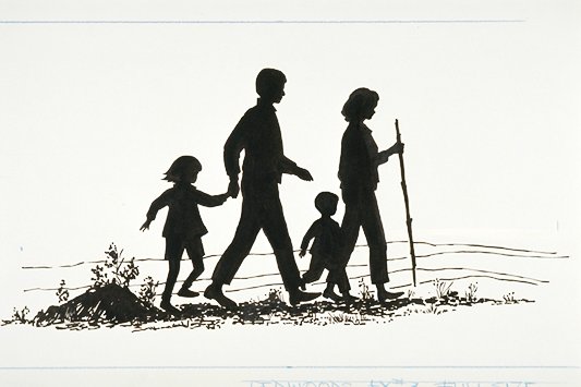 Silhouette of a family hiking along a trail.