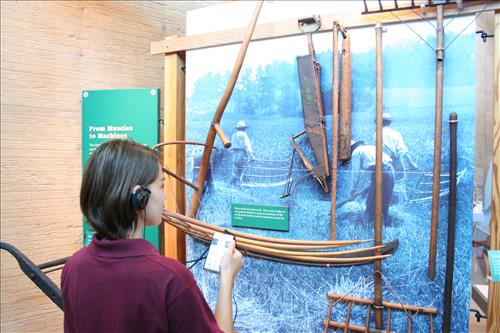 SCA Intern Using Audio Description tour to enjoy the displays at Homestead Heritage Center.