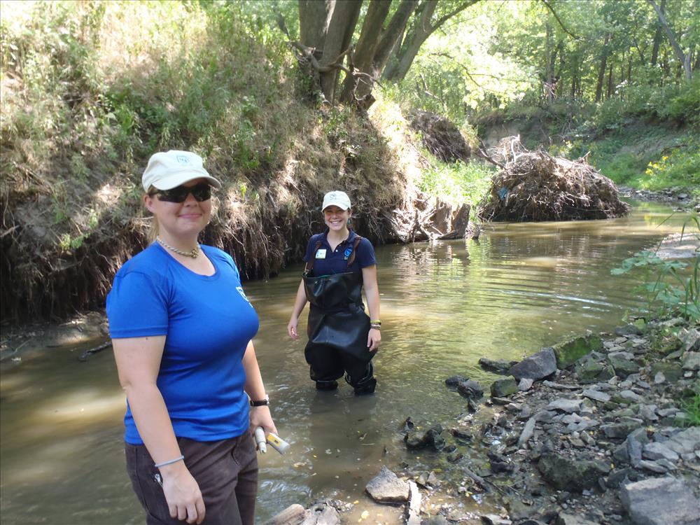 Two SCA interns standing in Cub Creek.