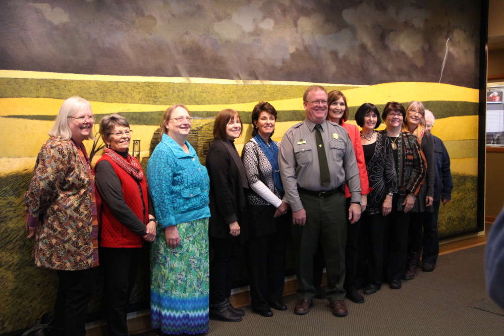 A group photo of artists and Superintendent Mark Engler