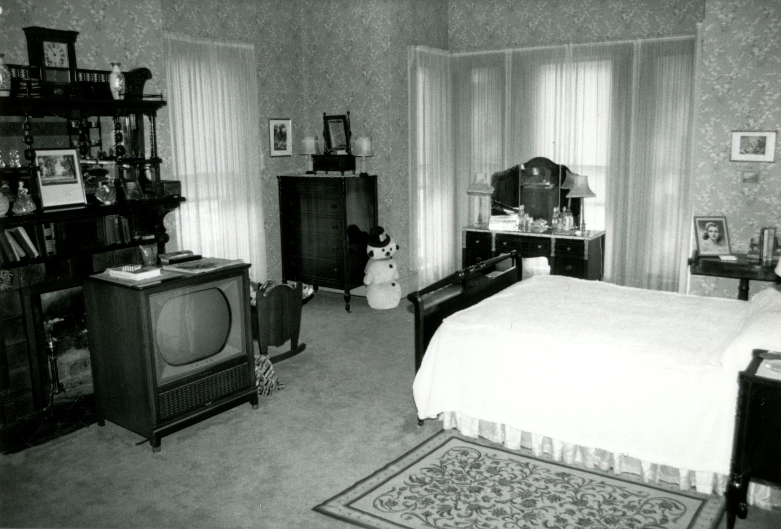 Master bedroom bed, fireplace, and vanity