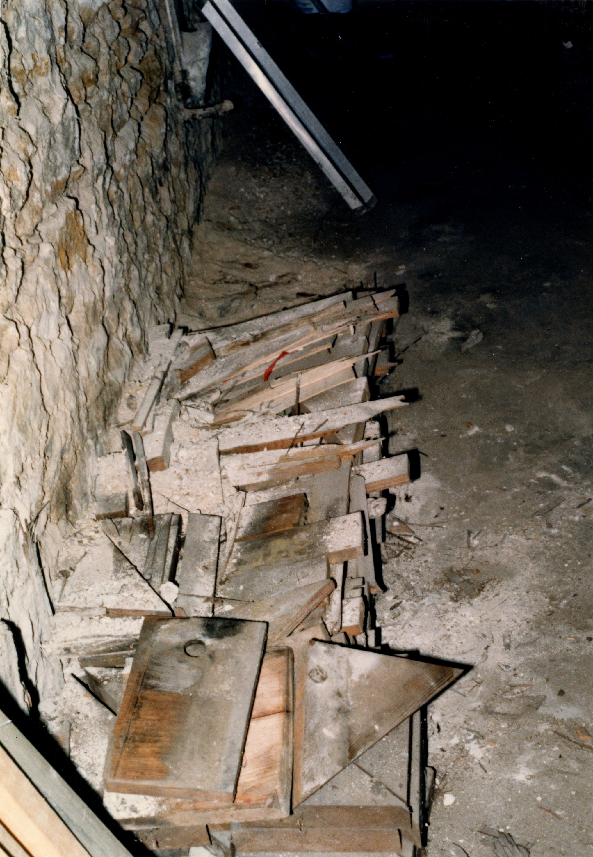 Wood pile along north wall after 1/2 of wood was discarded