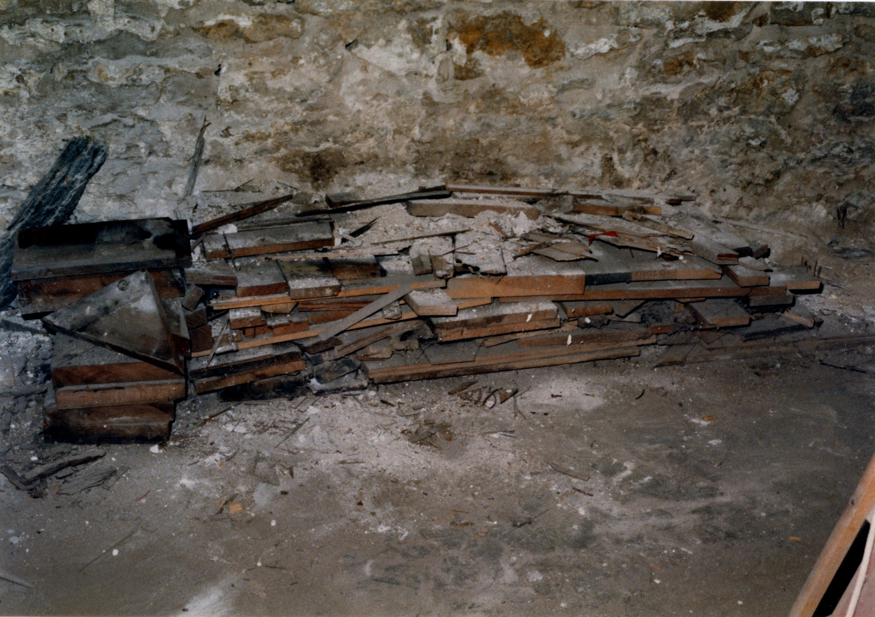 Wood pile along north wall after 1/2 of wood was discarded