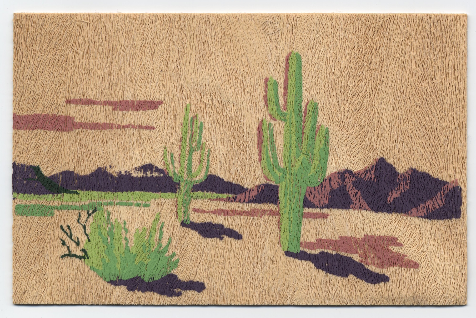 A postcard made of Yucca Wood with a desert landscape on the front and a letter written on the back.