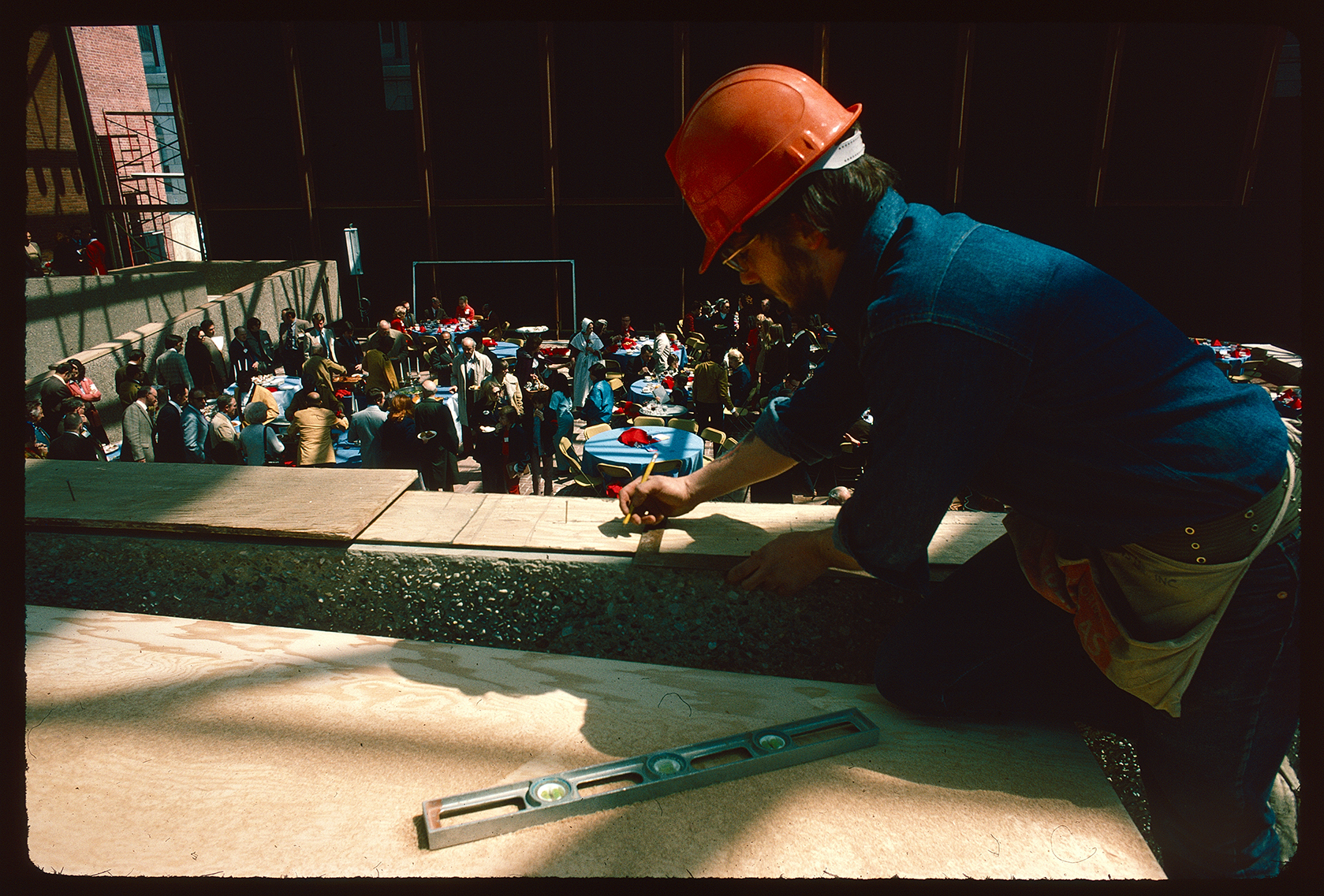 (Old) Visitor Center (101 South 3rd Street). Interior. Construction. ASTA luncheon inside unfinished building.  Looking east towards rear wall. Worker in immediate foreground.