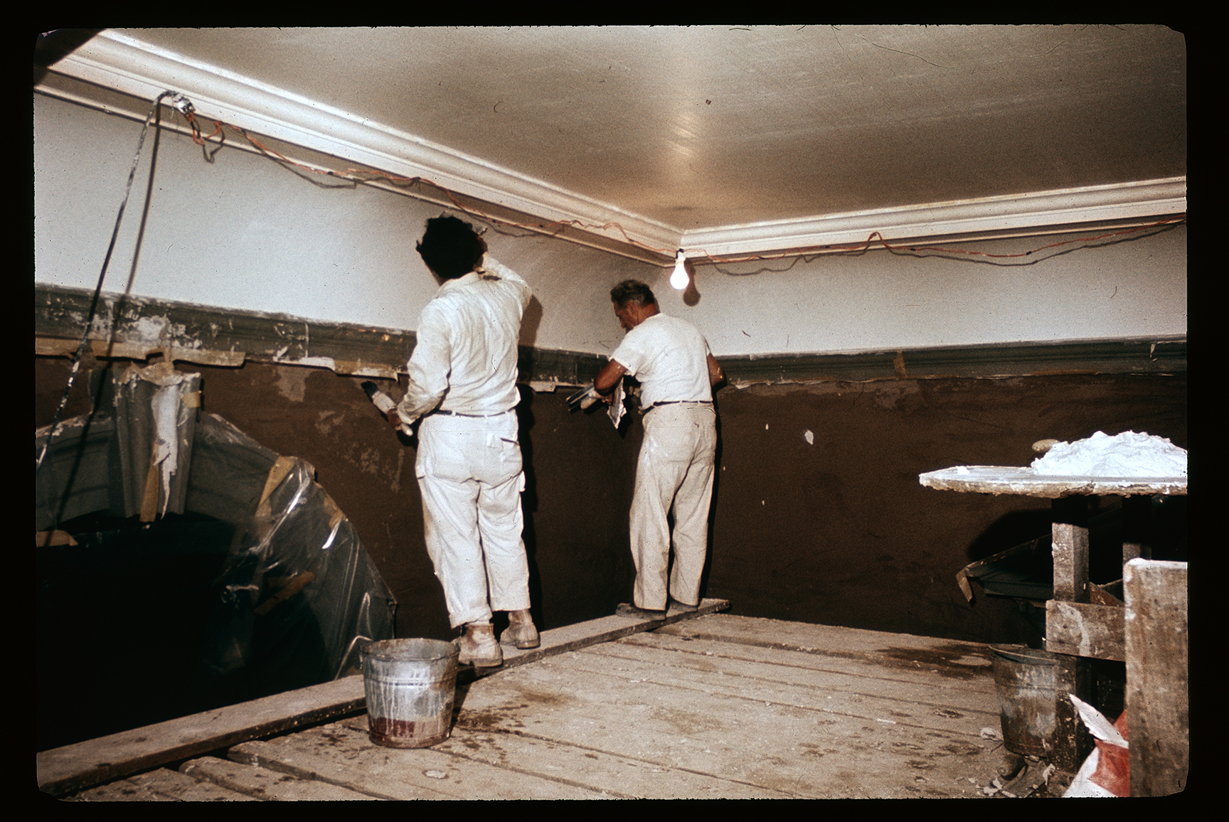 Independence Hall. Interior. 2nd floor, hall (lobby). Looking southwest. Renovation. Two men working on wall. Archway to Tower stairhall on left.