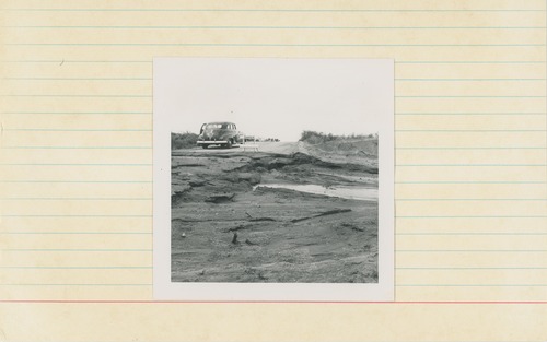 Black and white image of road damage