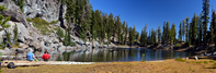 Hikers rest on a log at the edge of Terrace Lake