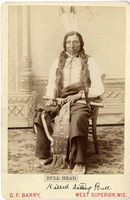 Bull Head in Full Regalia and Holding a Pipe