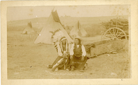 Chief Standing Elk and Black Horse Sitting in Front of Tipis