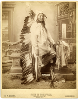 Rain in the Face in a Long Feathered Headdress, Holding a Maul and a Pipe