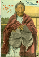 Hollow Wood's Wife, holding saddle bag.